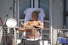 Blonde granny sunbathing on the Balcony